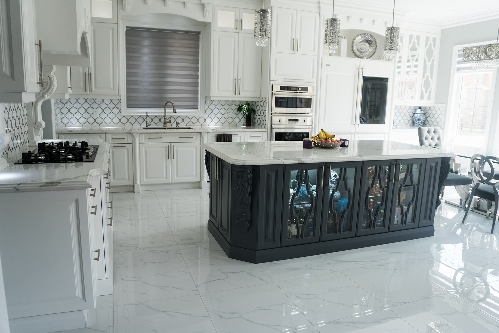 Grand white kitchen with dark glass-front island